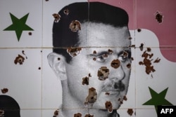 Bullet holes deface a mural depicting the toppled Syrian {resident Bashar al-Assad on the outskirts of Damascus.