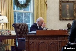 Biden speaks by phone with Ukrainian President Volodymyr Zelenskiy in the Oval Office at the White House on December 9.