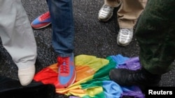 Antigay activists trample on a rainbow flag during a protest by gay-rights activists in Moscow in 2013.