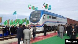 Locals from the Turkmen village of Ak Yayla join in the celebrations during the opening ceremony for a railway linking Kazakhstan, Turkmenistan, and Iran, which was inaugurated late last year.