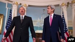 U.S. Secretary of State John Kerry (right) speaks with Azerbaijani President Ilham Aliyev in Washington on March 30. 