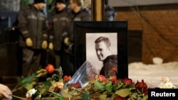 People lay flowers at the grave of Russian opposition politician Aleksei Navalny following his funeral at the Borisovskoye cemetery in Moscow on March 1. 