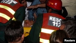 Rescue workers carry injured Pakistani cricketer-turned-politician Imran Khan, who is also chairman of the Pakistan Movement for Justice party, after he fell from a makeshift elevator during his campaign rally in Lahore on May 7.