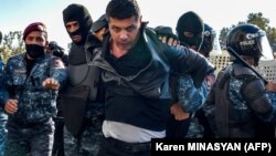 Armenian police detain a protester during an anti-government rally in Yerevan on November 11.