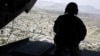 A U.S. soldier mans a weapon aboard a helicopter carrying U.S. Defense Secretary Jim Mattis as he arrived in the Afghan capital, Kabul, in April 2017.