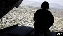 A U.S. soldier mans a weapon aboard a helicopter carrying U.S. Defense Secretary Jim Mattis as he arrived in the Afghan capital, Kabul, in April 2017.