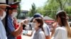 A security guard in a shopping center in the Kyrgyz capital, Bishkek, measures the temperature of visitors.