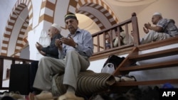 Crimean Tatars pray inside a mosque during the Eid al-Adha festival in Crimea. The annexed Ukrainian peninsula has been referenced in a new report on religious freedom that criticizes Russia's "repressive policies" toward people of certain faiths. 