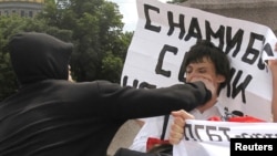 An activist is attacked during a gay pride parade that was unsanctioned by authorities in St. Petersburg, Russia, in June 2011.