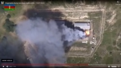 A video grab allegedly shows smoke billowing from what was said to be destroyed Armenian military equipment on the Azerbaijani-Armenian border on July 15.