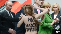 Femen activist Oleksandra Shevchenko described the reaction of Russian President Vladimir Putin (left) as "idiotic astonishment mixed with a smile and a stupid expression on his face." On her back is written "F*** you, Putin."