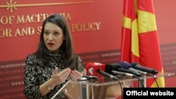 Caretaker Labor Minister Rashela Mizrahi makes an official press appearance in front of a board that uses the country's former, disputed name.