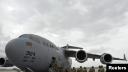 U.S. soldiers board a plane bound for Afghanistan at the U.S. Transit Center at Manas airport.