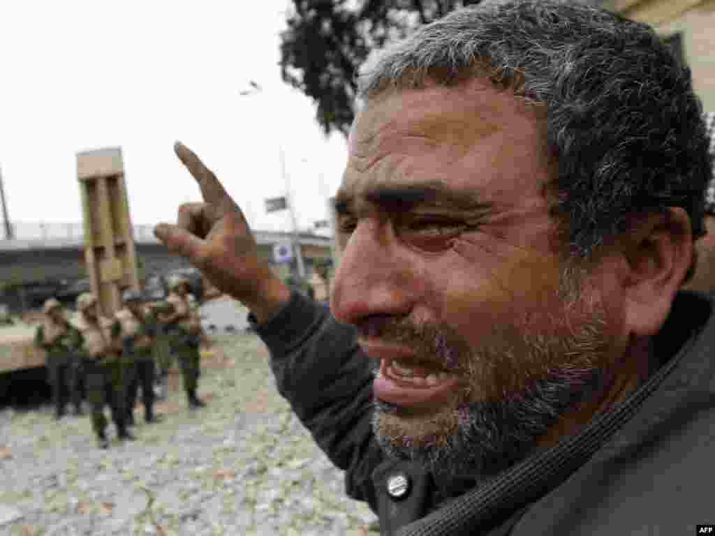 A protester cries as soldiers move in trying to convince demonstrators to dismantle their barricades in Tahrir Square.