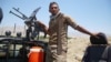 An Afghan soldier stands guard at a checkpoint after security forces cleared the area of Taliban militants in Afghanistan's Laghman Province on July 8.