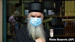 Metropolitan Amfilohije arrives to vote in parliamentary elections at a polling station in Cetinje on August 30.