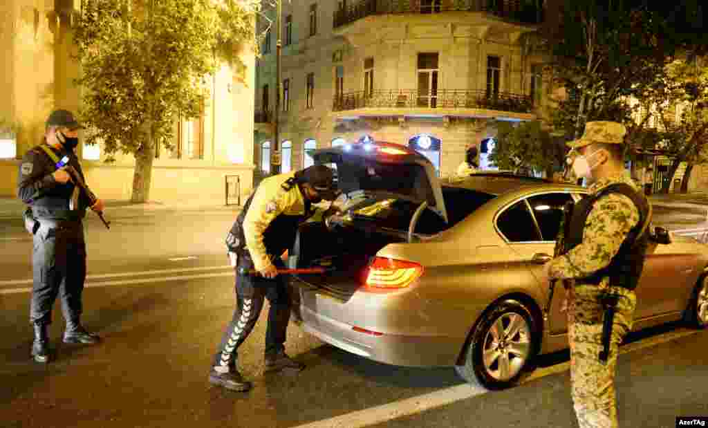 Police check a car in Baku shortly after the conflict broke out. Both Armenia and Azerbaijan announced martial law when the war in Nagorno-Karabakh began.&nbsp;