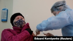 A woman receives an injection with the Sputnik-V vaccine at a hospital in Russia's Stavropol Region. 