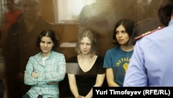 The three convicted members of Pussy Riot sit in a Moscow courtroom in August.