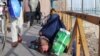 A woman begs on the street in Ghazni city. Many women have lost all income, despite being the sole wage earners for their families.