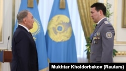 Then-Kazakh President Nursultan Nazarbaev (left) and National Security Committee Deputy Chairman Samat Abish attend an award ceremony in Astana in 2014.