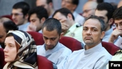 French national Clotilde Reiss (left) sits among fellow defendants in the trial that opened on August 8, including Iranian journalist Ahmad Zeidabadi (right)