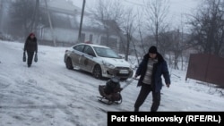 The eastern Ukrainian town of Debaltseve is at the center of the latest clashes between the Ukrainian military and pro-Russian separatists. As shells strike residential areas, some civilians have retreated to their basements for safety. Many have been living without electricity, gas, or water for over a week. Photojournalist Petr Shelomovskiy covered the harsh realities of daily life in Debaltseve for RFE/RL's Current Time TV program.