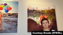 Russian-born photographer Alexander Kargaltsev stands in front of one of his portraits, of a gay couple posing in Central Park, at his exhibition launch on October 26.