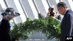 Kyrgyz President Kurmanbek Bakiev (right) and U.S. Ambassador Tatiana Gfoeller lay a wreath at a monument to victims of the 9/11 tragedy at Manas air base.