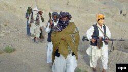 Taliban spokesman Zabihullah Mujahid with fellow militants in Helmand Province