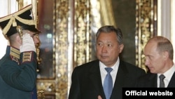 Russian Prime Minister Vladimir Putin (right) appears to have welcomed the ouster of Kyrgyz President Kurmanbek Bakiev.