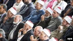 Audience members listen to a translation through headphones as U.S. President Barack Obama speaks at Cairo University on June 4.