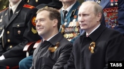 Russian President Dmitry Medvedev (left) and Prime Minister Vladimir Putin watch a military parade on Moscow's Red Square to celebrate Victory Day on May 9.