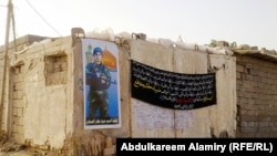 A poster on the home in Basra, Iraq, of Dhia Mutashar Gatie al-Issawi, an Iraqi who was fighting on behalf of the Syrian government before he was killed in Damascus.