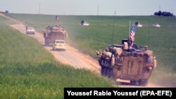 A convoy of U.S. troops and the People's Protection Units (YPG) Kurdish militia patrol near Syrian-Turkish border in 2017.