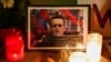 People light candles at a vigil following the death of Russian opposition leader Aleksei Navalny, near the Eiffel Tower in Paris on February 19.