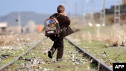 A Turkish boy walks along railroad tracks disused since the closure of the Turkish-Armenian border. The new agreement foresees the border reopening.