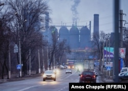 A man dashes across the road in front of Mariupol's Illich Steel and Iron Works on a gloomy afternoon on February 4.