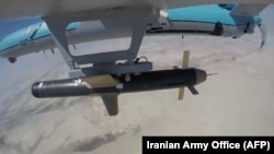 A handout picture provided by the Iranian Army shows an Iranian Simorgh drone carrying a weapon during a military exercise in September 2020 in the Persian Gulf, near the strategic Strait of Hormuz, in southern Iran.