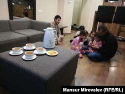 Afghan evacuee Jawed Ahmad Haqmal (right) and his family relax in their Kyiv hotel room.