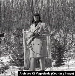 O.H. Osman, the Sudanese ambassador to Yugoslavia, scans the sky for game as he reloads his shotgun in Karadjordjevo.