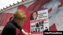 Demonstrators put up posters calling for the punishment of the "murderers of Sandro Girgvliani" at a rally in Tbilisi in April 2006.