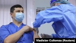 A health worker receives a dose of the AstraZeneca vaccine at a hospital in Chisinau on March 2.