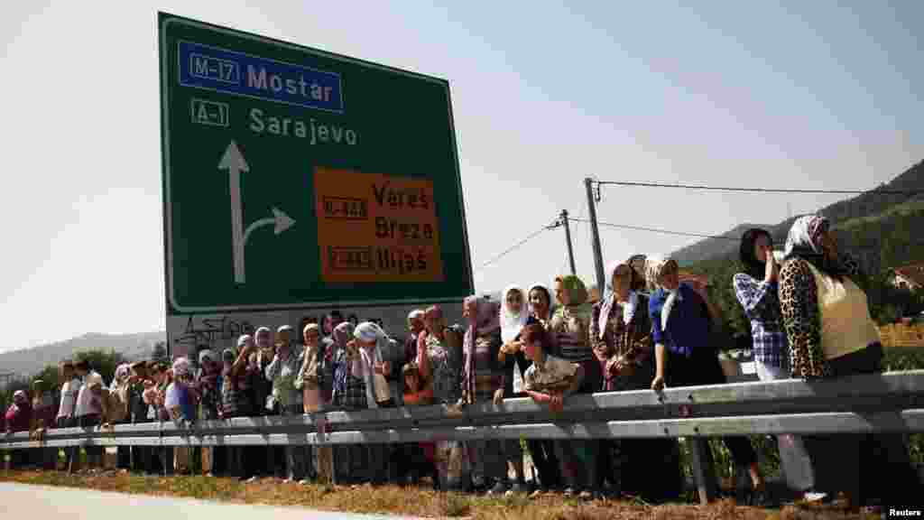 Many thousands of mourners lined the roads in Podlugovi on July 9 as the coffins passed.