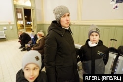 Tetyana and her two sons inside the train station in Przemysl, Poland. "My heart is broken -- to think of my husband and everything, all the relatives we have left in Ukraine," she says.