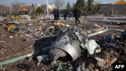 Rescue teams work amid debris after a Ukrainian plane carrying 176 passengers crashed near Imam Khomeini airport in the Iranian capital Tehran on January 8. 