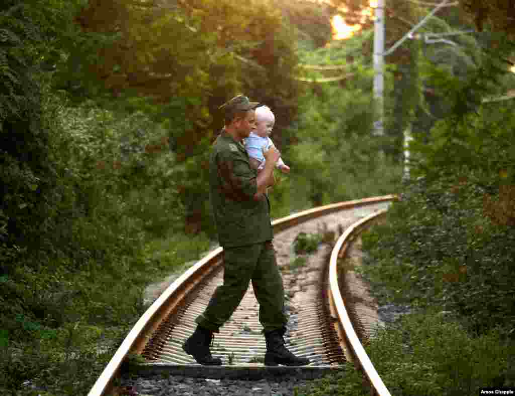 A Russian soldier from the city of Smolensk spends time with his visiting family. Some 3,000 Russian soldiers are now stationed inside Abkhazia.