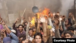 Members of the Christian community in Lahore protest on March 10 after a mob set fire to their homes.