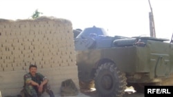 Kyrgyz soldier rests near the area where militants were killed