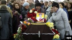 Mourners grieve at the coffin of Nina Lushchenko, a victim of the Russian MetroJet Airbus A321 crash in Egypt, during her funeral service at a church in Veliky Novgorod on November 5. 